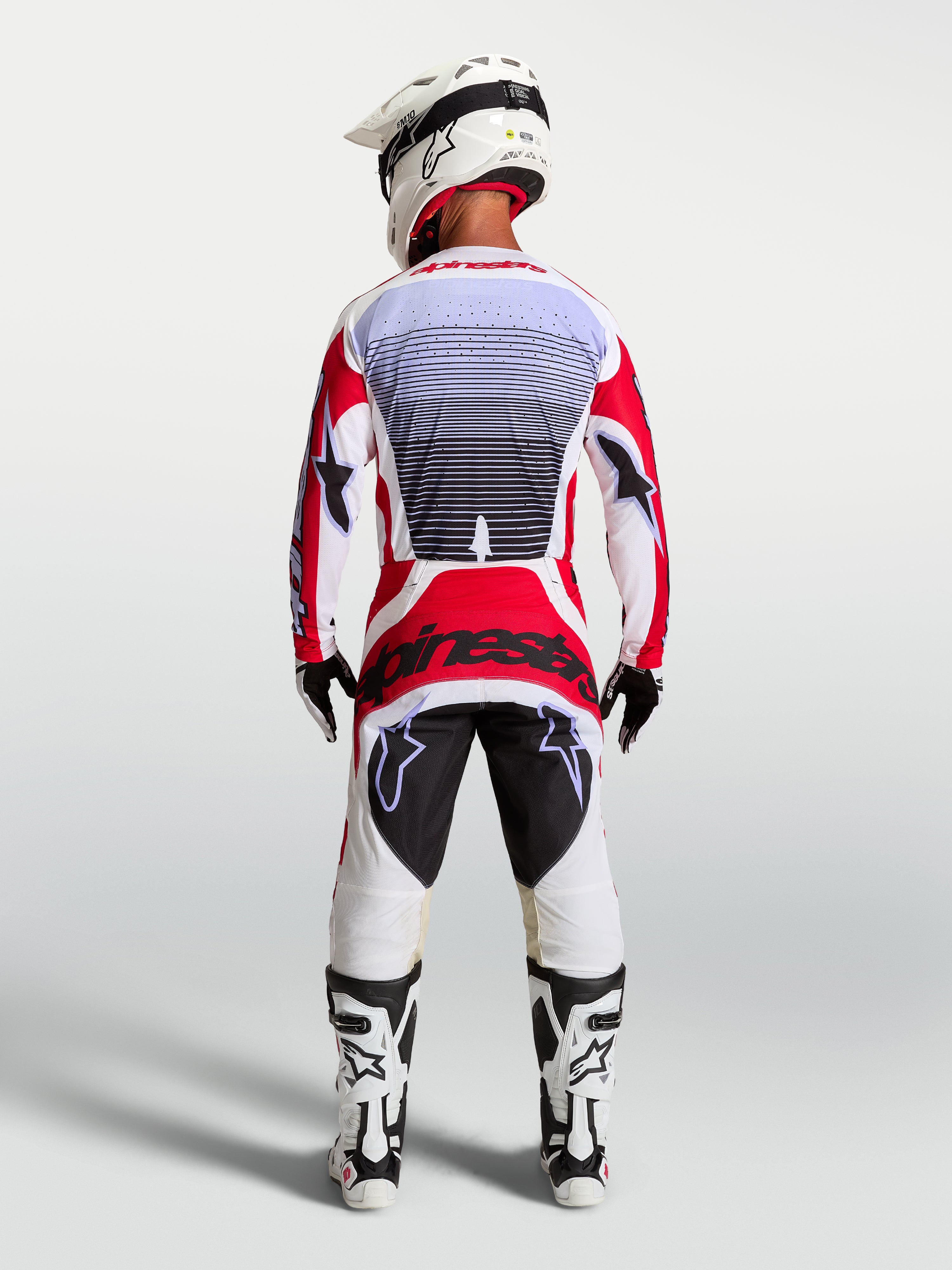 Alpinestars Pantaloni Techstar Maven, pantaloni motocross rosso e bianco, vista posteriore, vestibilità da gara atletica.