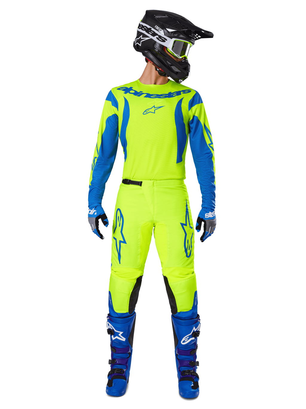 Alpinestars 2025 Fluid Haul Pants, pantaloni da motocross, giallo fluo e blu, indossati come kit da gara completo con maglia coordinata, stivali blu e casco nero, con vistosi loghi blu sulle cosce e pannelli neri sulle ginocchia