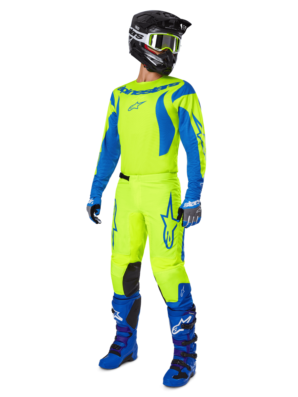 Alpinestars 2025 Fluid Haul Pants, pantaloni da motocross, giallo fluo e blu, indossati come parte di un set completo da gara con maglia coordinata, stivali blu e casco nero, design ad alta visibilità per la guida fuoristrada