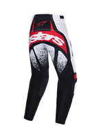 Alpinestars pantaloni Techstar Nomur 2026, pantaloni da motocross, nero, bianco e rosso, vista posteriore con logo rosso e bianco sulla seduta, motivi puntinati in bianco e nero sulle cosce e costruzione multi-pannello ad alte prestazioni.