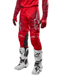 Alpinestars pantaloni Racer Hoen 2024, pantaloni da motocross, rosso Marte e bordeaux, indossati con maglia e guanti rossi coordinati e stivali bianchi, con inserti in pelle nera sulle ginocchia e loghi bianchi, abbigliamento tecnico resistente per fuoristrada