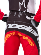 Alpinestars Limited Edition Techstar Deep Pants, pantaloni da motocross, nero, bianco e rosso acceso, con design multi-pannello, ginocchia rinforzate e pannelli elasticizzati a 4 vie per prestazioni fuoristrada.