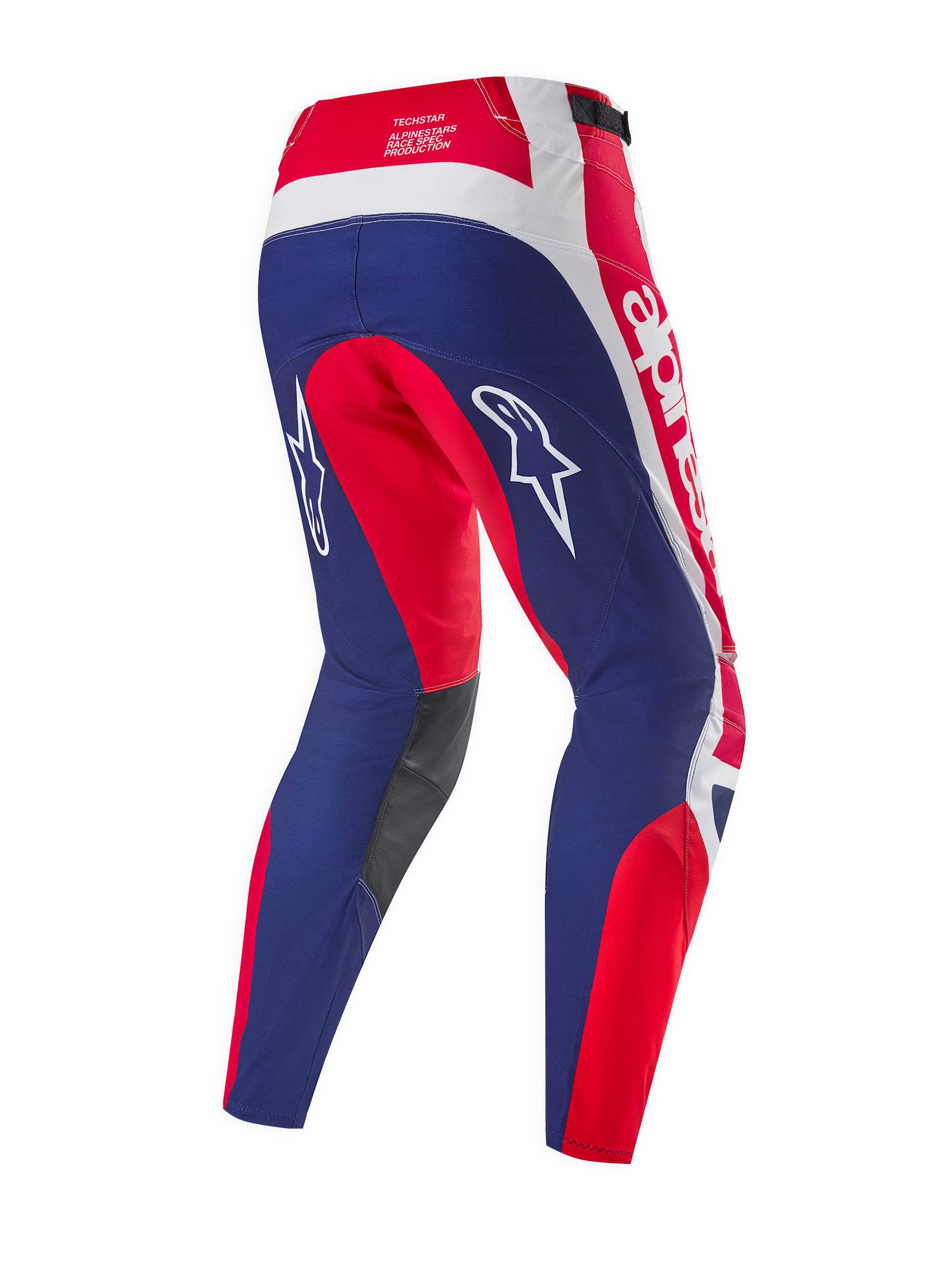 Alpinestars Limited Edition Techstar Fortitude Pants, pantaloni da motocross, rosso acceso, bianco e blu, vista posteriore con pannelli ergonomici da gara, loghi Alpinestars bianchi e pannelli interni alle ginocchia grigio scuro.