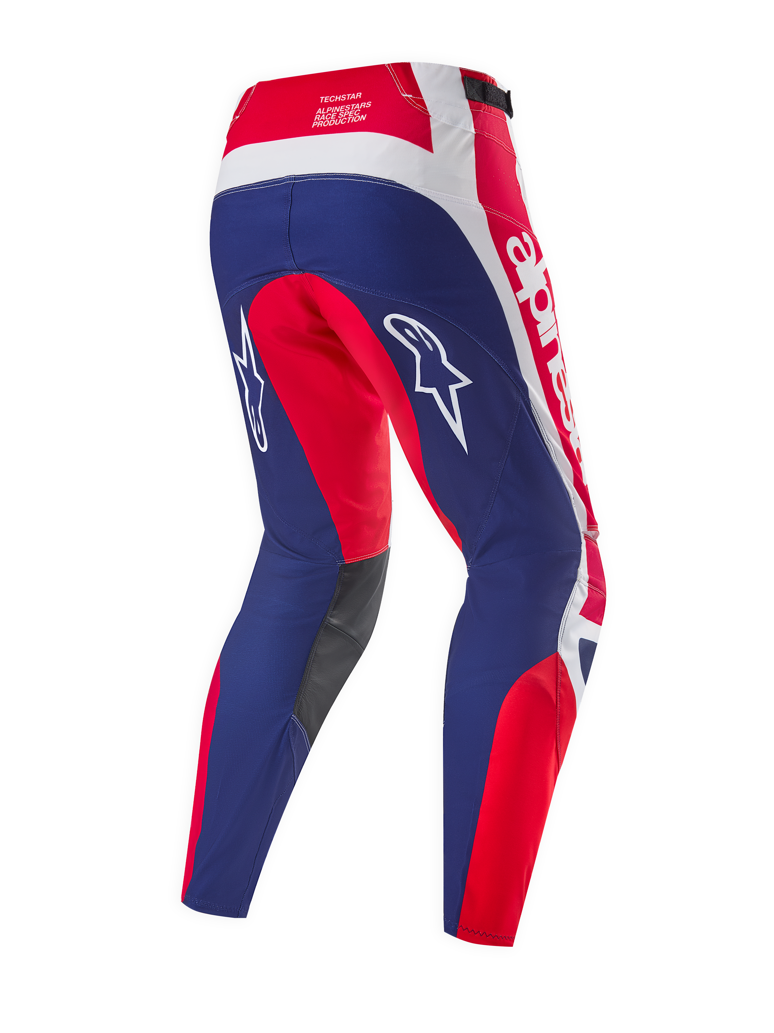 Alpinestars Limited Edition Techstar Fortitude Pants, pantaloni da motocross, rosso acceso, bianco e blu, vista posteriore con pannelli ergonomici da gara, loghi Alpinestars bianchi e pannelli interni alle ginocchia grigio scuro.