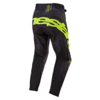 Alpinestars Pantaloni Techstar Rantera 2024, pantaloni da motocross, nero, blu navy e giallo fluo, vista posteriore con logo giallo fluo sulla seduta, pannelli blu navy e tessuto tecnico nero per corse fuoristrada