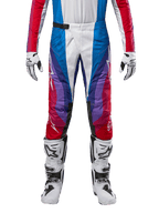 Alpinestars 2024 Techstar Pneuma Pants, pantaloni da motocross, Blu, Rosso Marte e Bianco, caratterizzati da un design angolare multicolore con accenti viola, abbinati a stivali da motocross bianchi e neri e guanti coordinati, vestibilità racing atletica per prestazioni fuoristrada