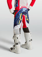 Alpinestars Pantaloni Supertech Dyna Ragazzo, pantaloni da motocross rosso fuoco e blu navy per giovani piloti, vista posteriore.