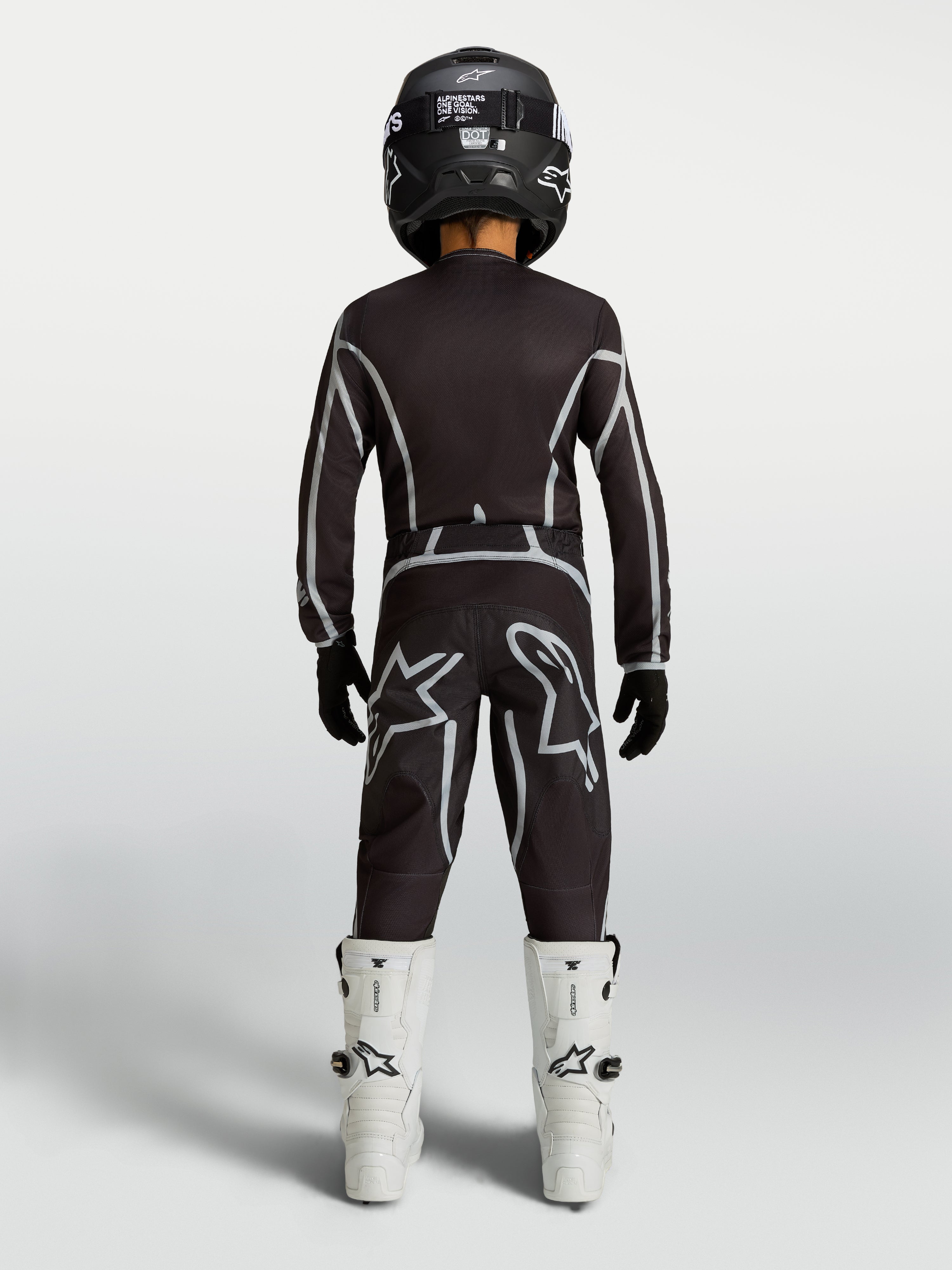Alpinestars pantaloni Fluid Apex V2 ragazzo, pantaloni da motocross neri e argento, vista posteriore, vestibilità ergonomica per giovani piloti.