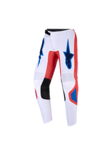 Pantaloni Alpinestars Youth Fluid Grid 2026, pantaloni da motocross per ragazzi, arancione e blu UCLA su base bianca, con pannelli interni alle ginocchia in pelle sintetica nera e loghi Alpinestars sulle cosce, design ergonomico pre-curvato per guida off-road.