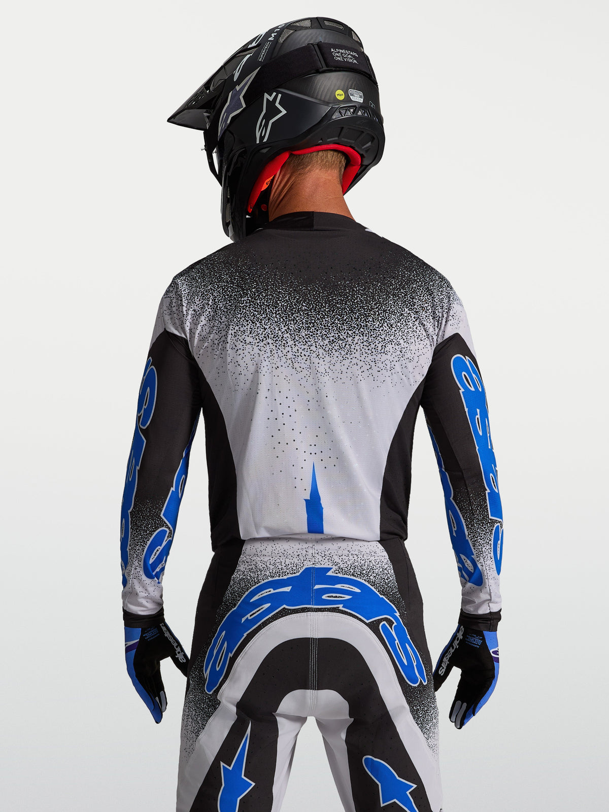 Alpinestars Maglia Supertech Hiten AFD, maglia da motocross per uomo, nero e blu, vista posteriore con vestibilità atletica.