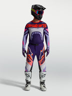 Alpinestars Maglia Supertech Dyna, maglia da motocross racing per uomo, viola e rosa fluo, vestibilità atletica e ultra-leggera, indossata con casco e stivali coordinati per competizioni off-road.