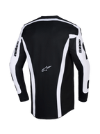 Alpinestars Maglia Racer Riway 2026, maglia da motocross, bianco e nero, vista posteriore con base nera, strisce verticali bianche e pannelli sulle maniche, logo Astars al centro della schiena, scritta 'astars' sulle maniche e taglio posteriore allungato