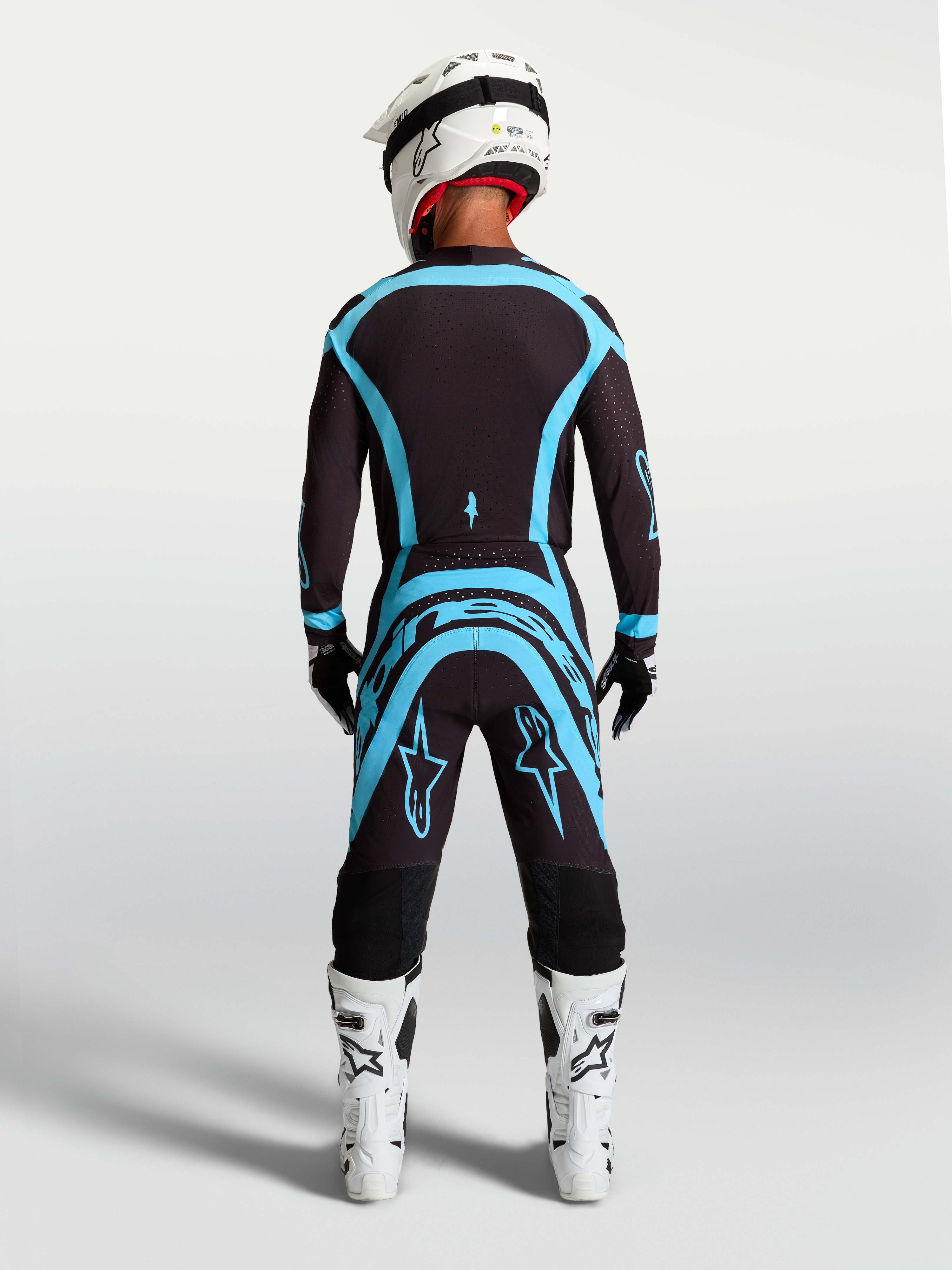 Alpinestars Completo Supertech Vesta, maglia e pantaloni da motocross da uomo, nero e turchese, vista posteriore, vestibilità atletica per gare off-road