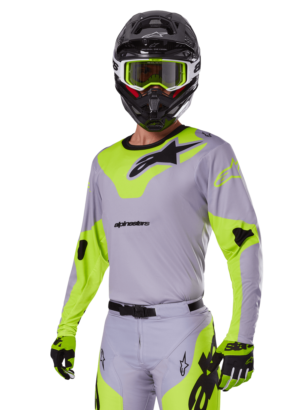 Pilota di motocross con set completo Alpinestars Racer Veil 2025 grigio e verde fluo, maglia e pantaloni grigio chiaro con pannelli giallo-verde neon e loghi neri, guanti abbinati, casco nero con occhiali verde neon, abbigliamento professionale da gara fuoristrada