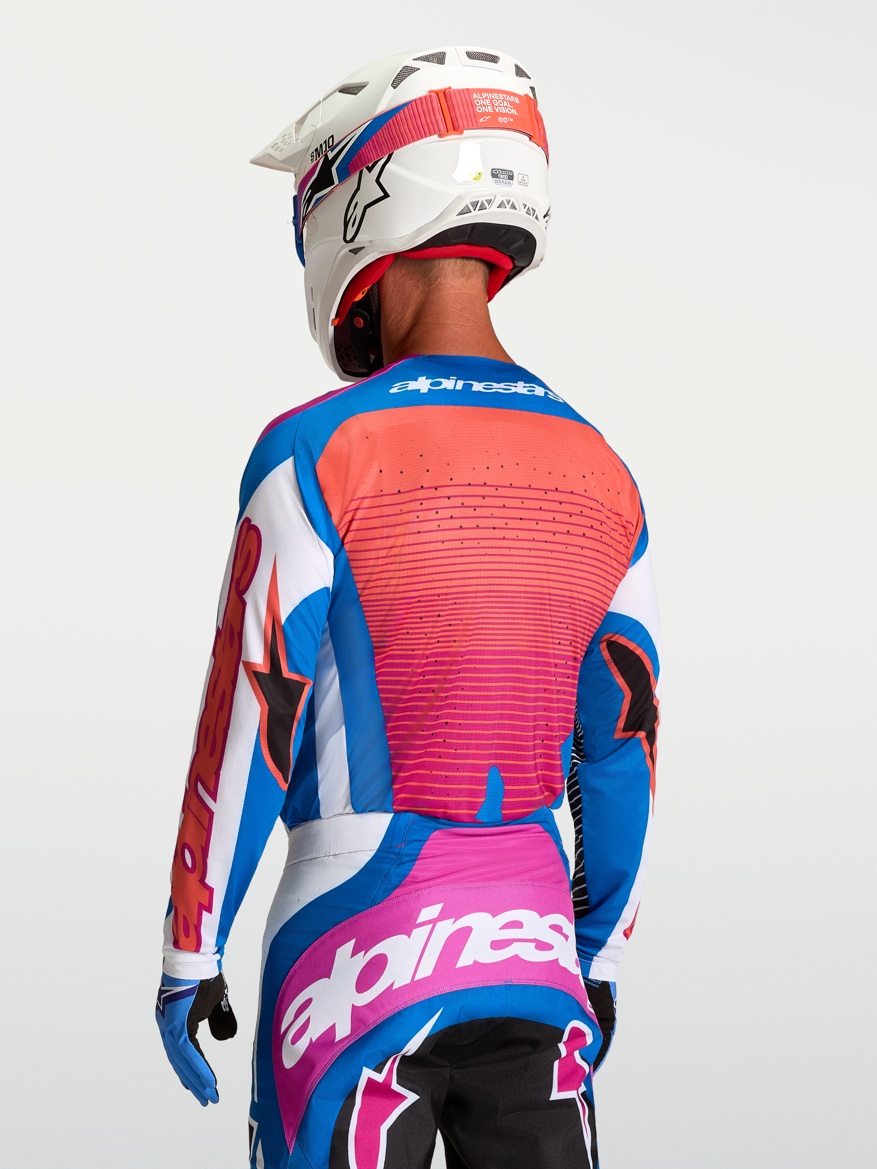Alpinestars Maglia Techstar Maven, maglia da motocross da uomo vista posteriore, bianco, hot coral e blu blithe, con ventilazione laser e inserti stretch.
