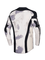 Alpinestars 2026 Racer Lahnd Jersey, maglia da motocross, Sand Camo con motivi a pennellata bianco sporco e grigio, vista posteriore con pannelli verticali in mesh nero, colletto nero e profilo posteriore allungato per una maggiore copertura
