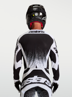 Alpinestars maglia Techstar Swan, maglia motocross da uomo, bianco e nero, vista posteriore, vestibilità atletica da gara e dettagli grafici