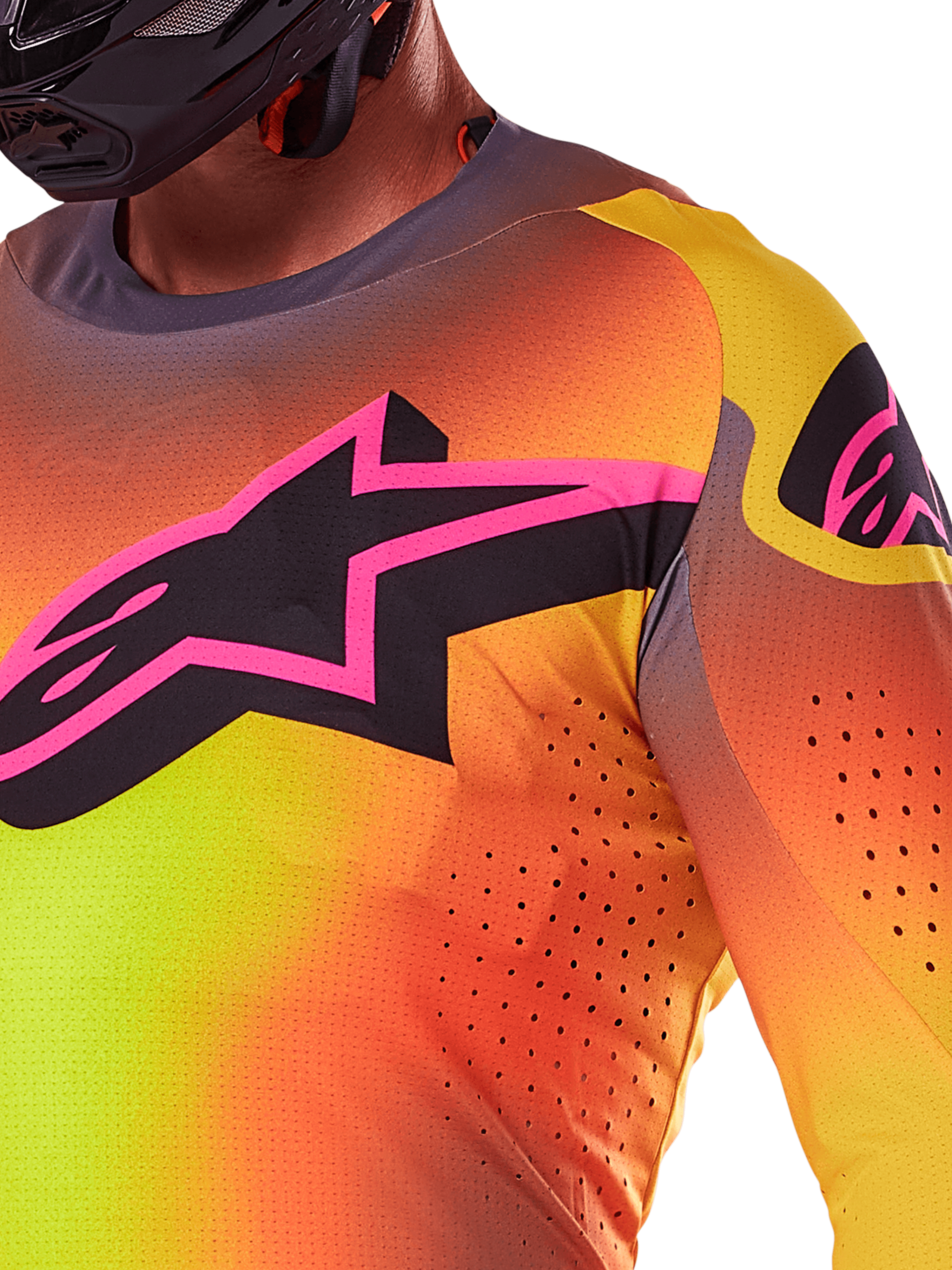 Primo piano della maglia Alpinestars Supertech Lipan 2025 in giallo e rosa, caratterizzata da un vivace design sfumato, un grande logo a stella nero con bordo rosa sul petto e perforazioni tagliate al laser visibili per un flusso d'aria ottimizzato.
