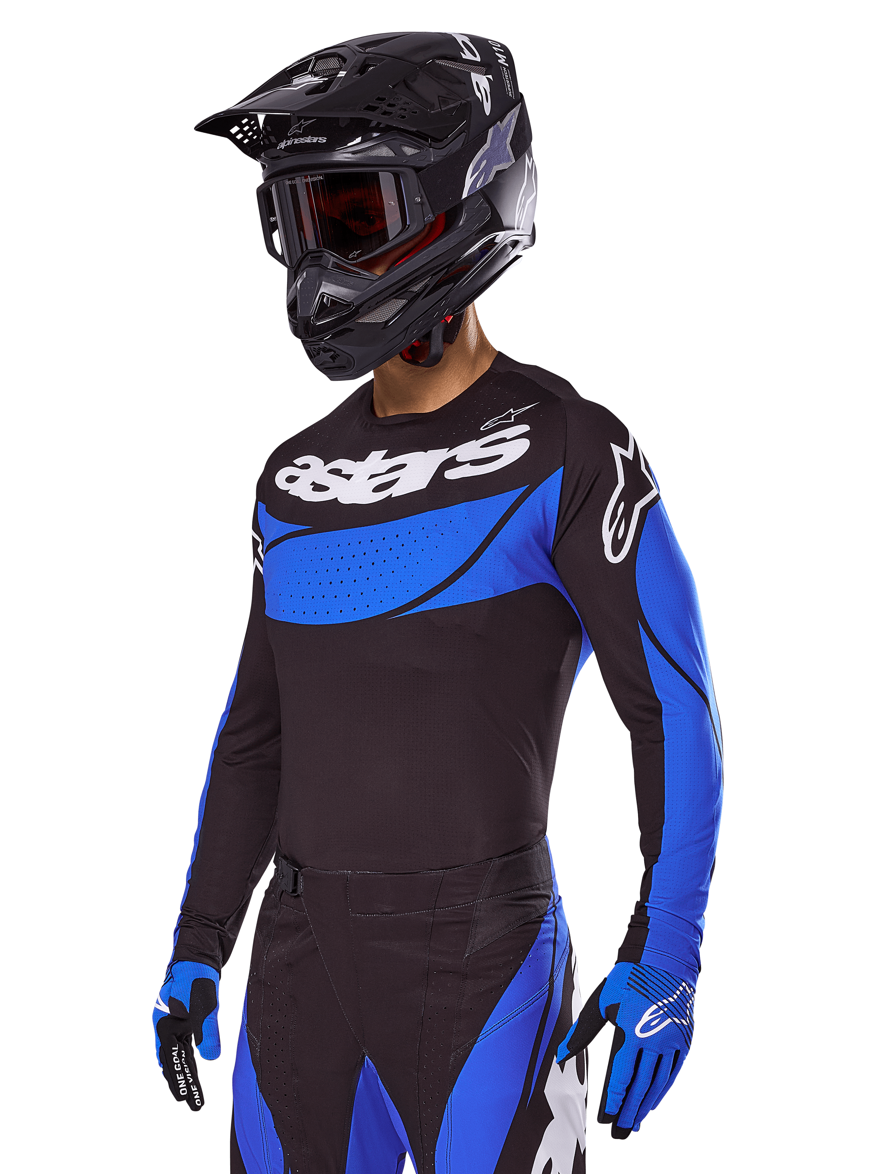 Pilota di motocross con il set Alpinestars Techstar Dreem 2025, maglia nera con pannelli blu stile traforato e branding bianco, pantaloni coordinati neri e blu, casco da corsa nero e guanti blu, abbigliamento tecnico per motocross off-road.