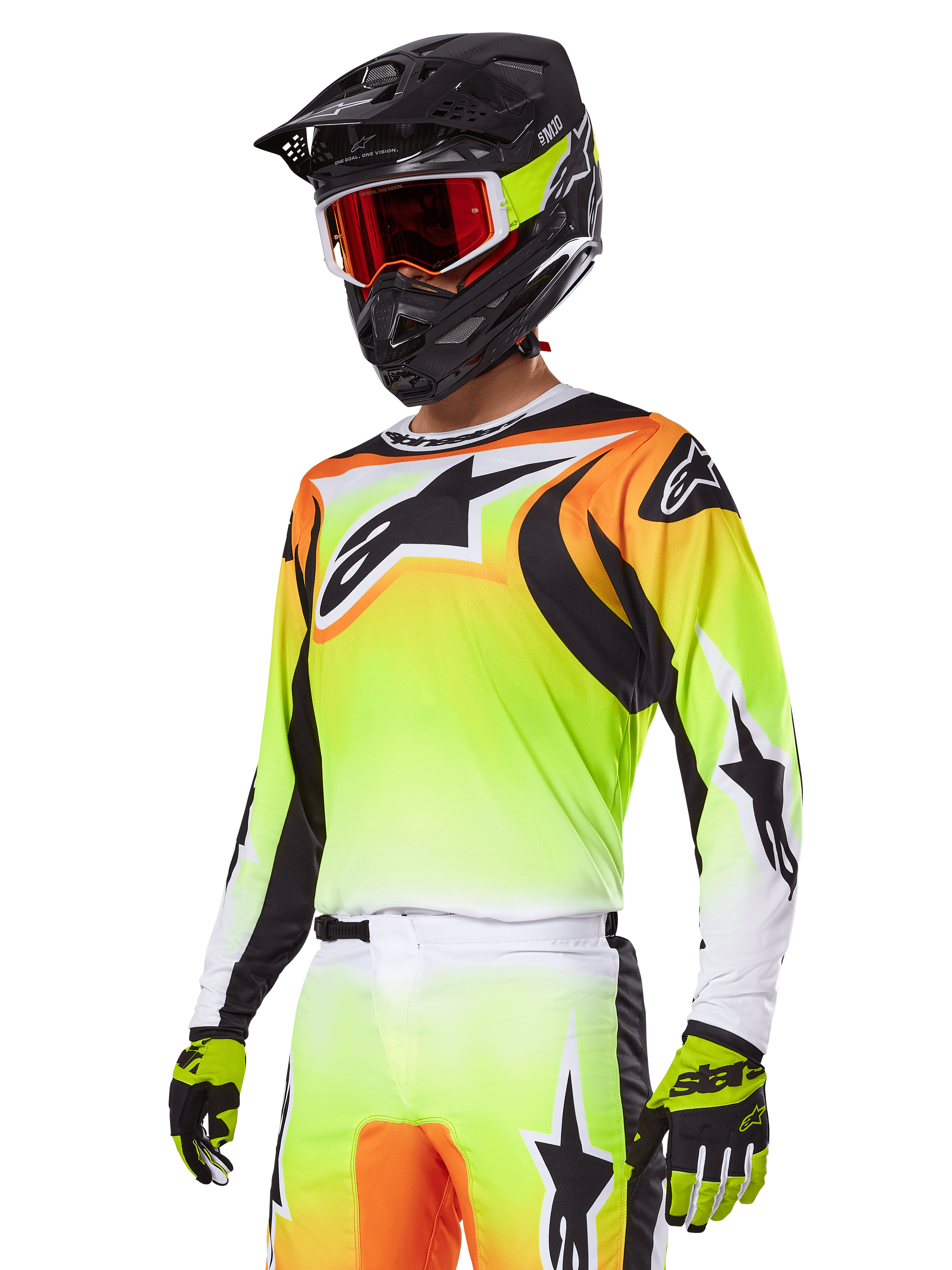 Pilota di motocross con completo Alpinestars 2025 Fluid Wurx, maglia con sfumatura gialla e arancione con dettagli neri e grandi loghi a stella, pantaloni da motocross coordinati, casco integrale nero con maschera a lenti rosse e guanti gialli, outfit ad alte prestazioni per competizioni off-road