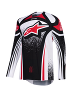 Alpinestars Techstar Nomur Jersey 2026, maglia da motocross, nero, bianco e rosso, con un grande logo Astars rosso sul petto, grafiche puntinate, maniche lunghe e vestibilità atletica da gara per competizioni off-road ad alte prestazioni.