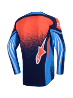 Alpinestars Techstar Nomur Jersey 2026, maglia da motocross, vista posteriore, blu navy scuro, arancione e blu UCLA, con sfumatura arancione puntinata sul retro, maniche blu con grafiche bianche a onda e logo Alpinestars arancione sulla parte inferiore.
