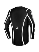 Alpinestars 2026 Fluid Apex Jersey, maglia da motocross, nero con profili curvi bianchi, vista posteriore che mostra il taglio ergonomico e un piccolo logo bianco, maglia tecnica a maniche lunghe per corse fuoristrada