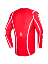 Alpinestars 2026 Fluid Apex Jersey, rosso e bianco, vista posteriore della maglia da motocross a maniche lunghe con linee curve bianche, logo a stella in basso e scritta Alpinestars bianca sulle maniche, progettata per gare fuoristrada
