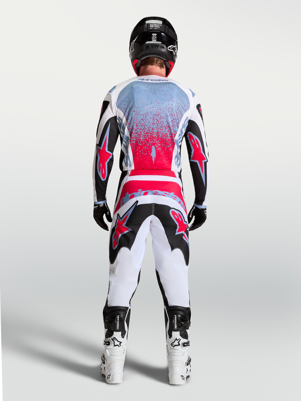 Alpinestars maglia Fluid Drag, maglia da motocross da uomo, nero e rosso fluo, vista posteriore su un pilota.