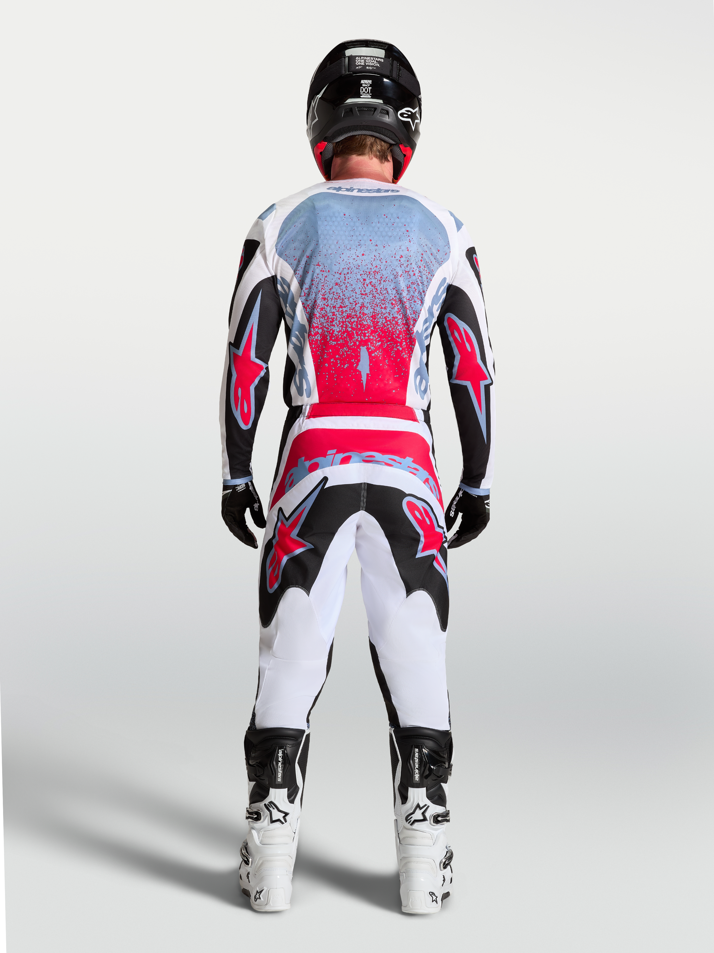 Alpinestars maglia Fluid Drag, maglia da motocross da uomo, nero e rosso fluo, vista posteriore su un pilota.