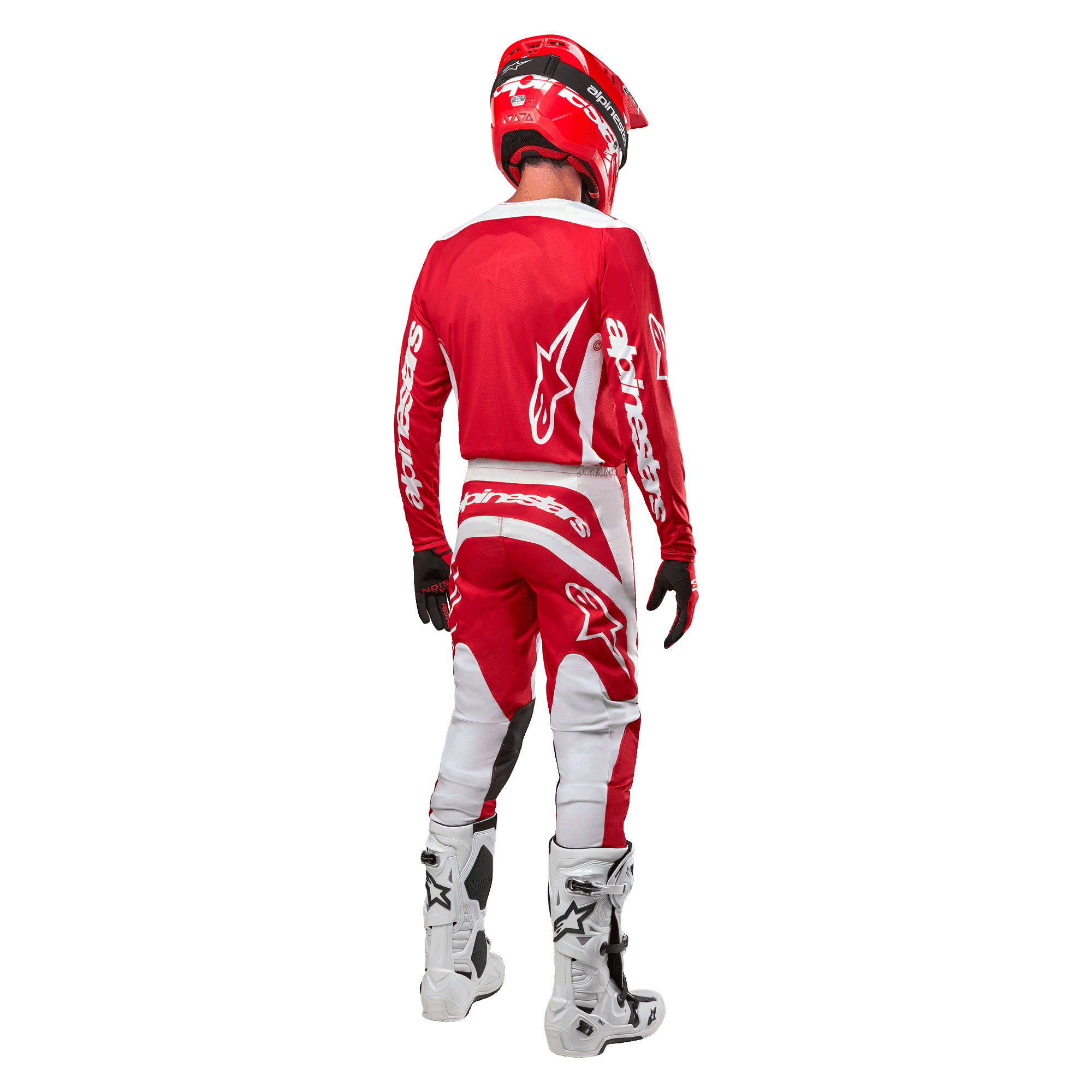 Vista posteriore di un pilota di motocross che indossa la maglia Alpinestars Fluid Lurv 2024 in Mars Red White, abbinata a pantaloni coordinati rossi e bianchi, stivali off-road bianchi e un casco rosso, mostrando il design posteriore della maglia e il marchio Alpinestars.