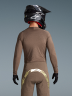 Alpinestars completo Supertech Air Gold edizione limitata, vista posteriore motocross marrone e oro con ventilazione laser.