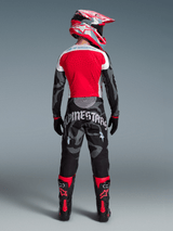 Alpinestars Techstar Beast Coast Edizione Limitata, completo motocross rosso e camo grigio con dettagli gotici.