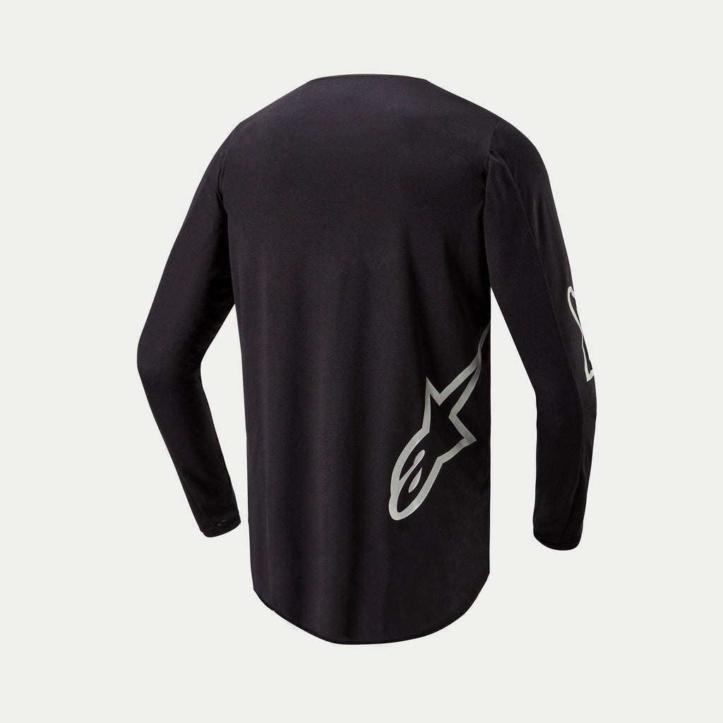 Alpinestars 2024 Fluid Graphite Jersey, maglia da motocross, nero e argento, vista posteriore con logo a stella argento sul lato inferiore, design a maniche lunghe con parte posteriore allungata per una maggiore copertura nella guida fuoristrada