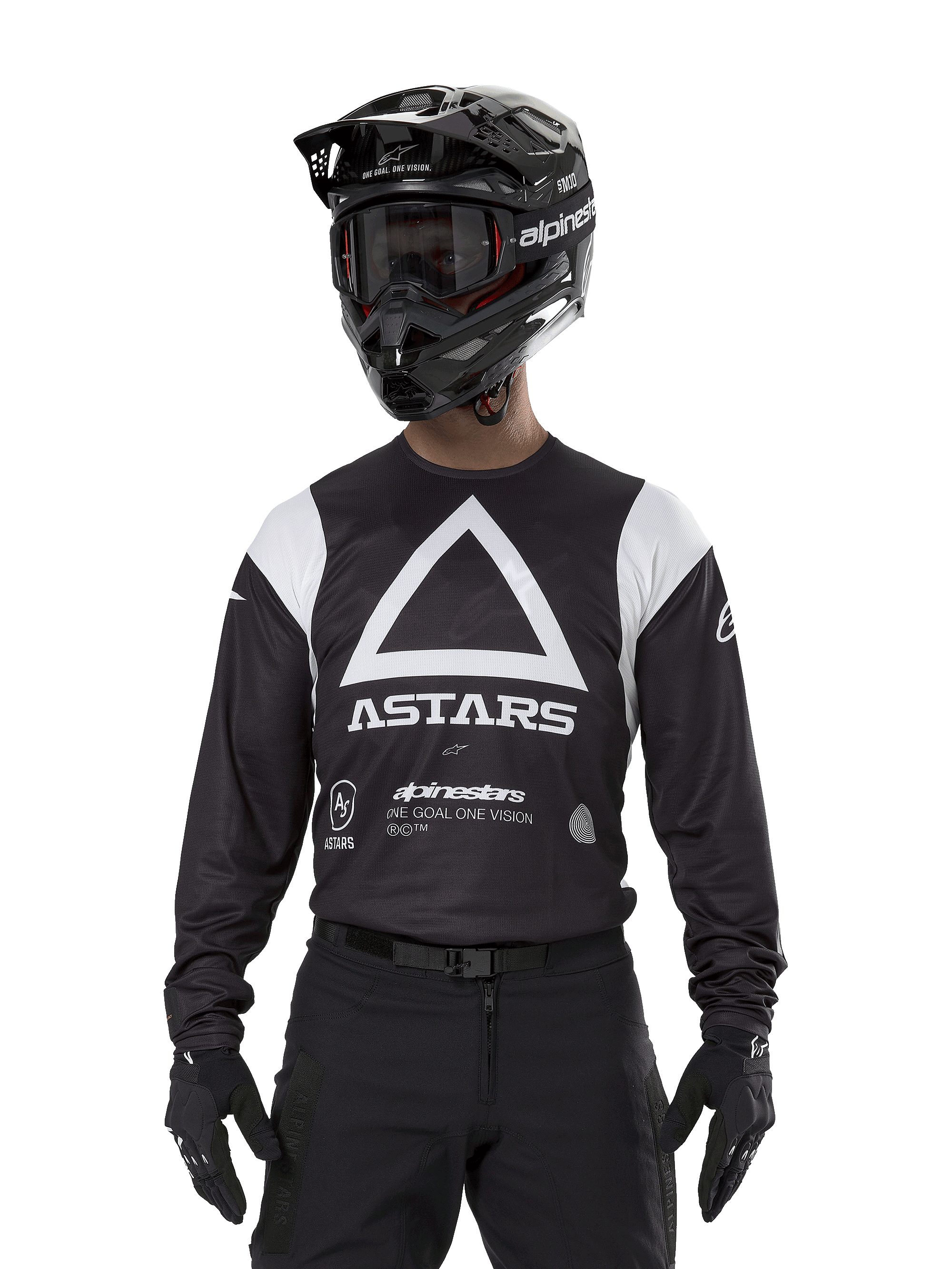 Alpinestars Techdura Jersey, nero, con grande grafica a triangolo bianco sul petto e logo ASTARS, pannelli bianchi sulle spalle, indossata con casco da motocross nero, occhiali e attrezzatura off-road nera coordinata