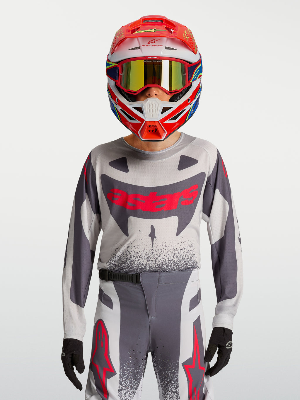 Alpinestars Ragazzo Supertech Swan Gear Set, completo da motocross grigio e rosso fluo in mesh stretch traspirante.