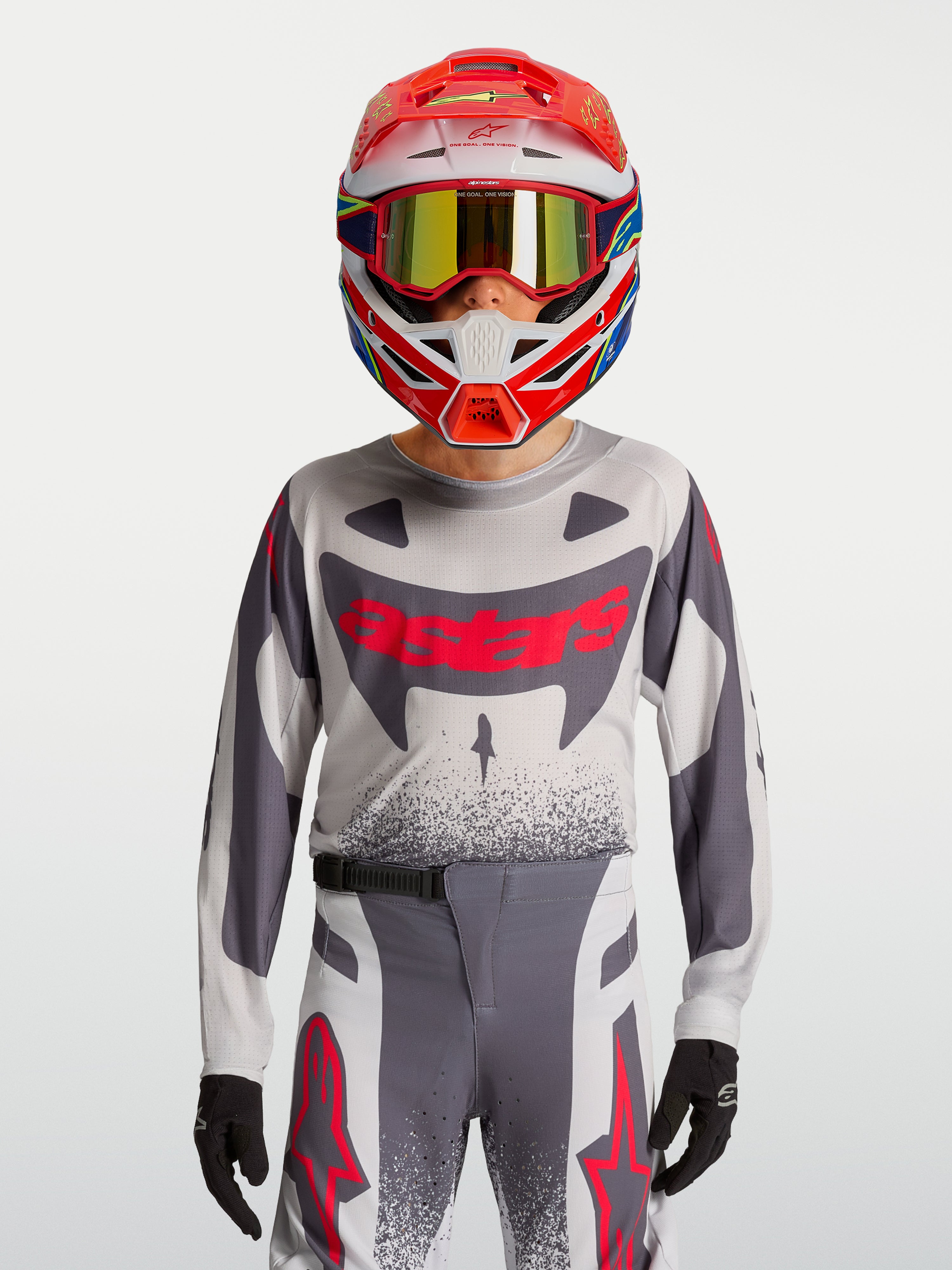 Alpinestars Ragazzo Supertech Swan Gear Set, completo da motocross grigio e rosso fluo in mesh stretch traspirante.
