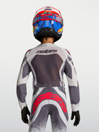 Alpinestars maglia e pantaloni Supertech Swan Ragazzo, grigi e bianchi con accenti rosso fluo, vista posteriore.