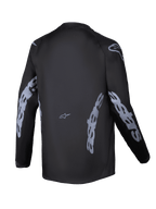 Maglia Alpinestars Youth Racer Graphite 2025, vista posteriore, nero e grigio, maglia da motocross a maniche lunghe con branding Alpinestars grigio su maniche e fianchi, tessuto traspirante con taglio posteriore allungato per la guida off-road