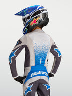 Alpinestars Maglia Fluid Drag Ragazzo, maglia da motocross per ragazzi, grigio e blu con grafica splash, vista posteriore.