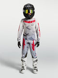 Alpinestars maglia Fluid Lone ragazzo 2027 e completo motocross, grigio mimetico e rosso, abbigliamento tecnico da off-road.