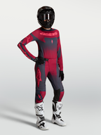 Alpinestars Stella Techstar Swan Maglia e Gear Set, completo motocross da donna, rosso e grigio scuro, con stivali bianchi.