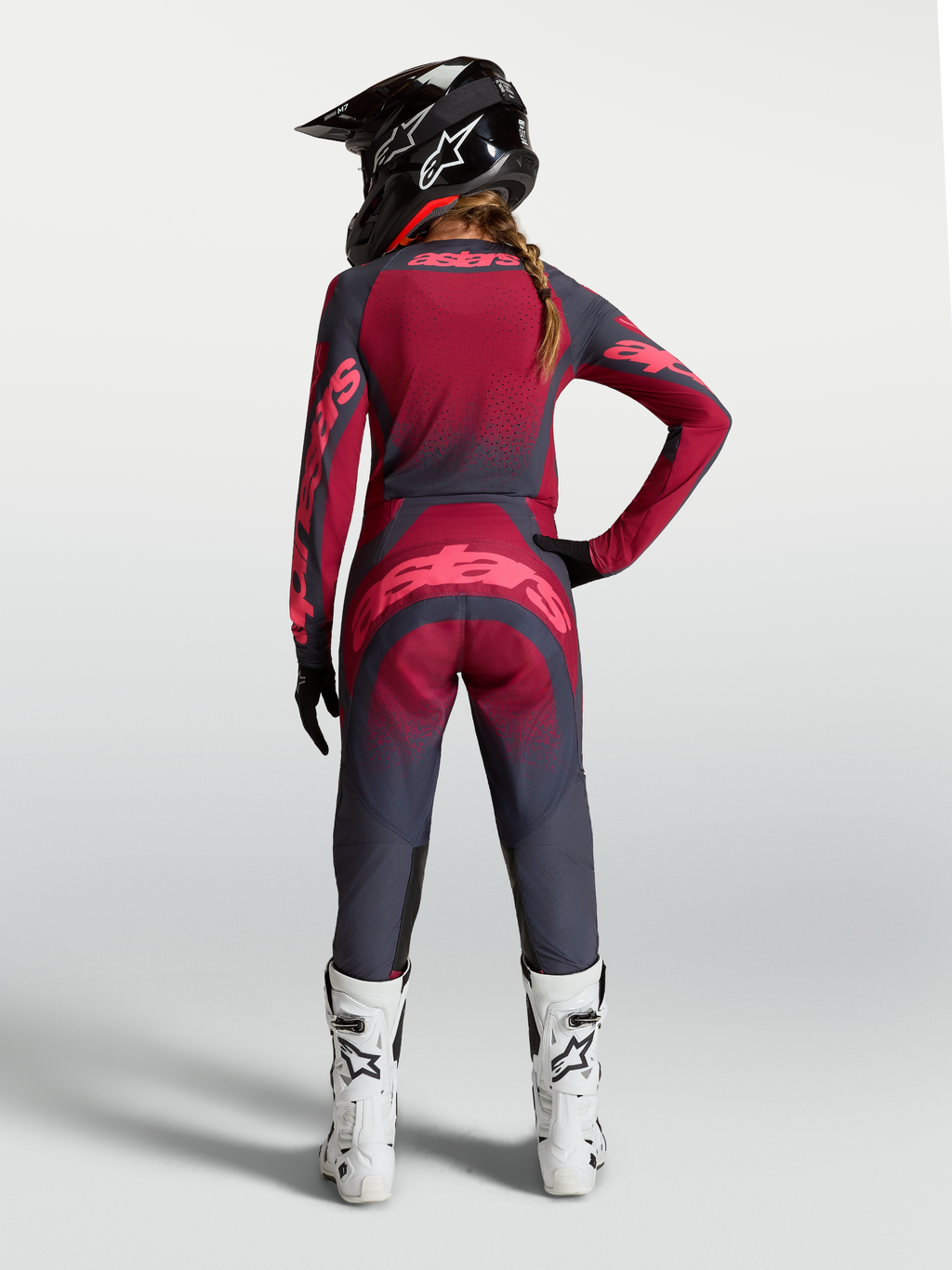 Alpinestars maglia Stella Techstar Swan, completo da motocross da donna rosso e grigio scuro, vista posteriore su modella.