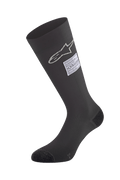 Alpinestars ZX V4 Socks, calze da auto racing nere, con logo a stella bianco ed etichetta di certificazione FIA, design senza cuciture ad altezza ginocchio con punta e tallone rinforzati, base layer ignifugo per il motorsport