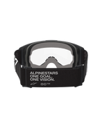 Alpinestars Vision OTG, maschere da motocross, nero e grigio, vista posteriore che mostra l'ampia fascia in tessuto nero con lo slogan del brand, imbottitura facciale multistrato grigia, lente trasparente, progettate per l'alloggiamento di occhiali da vista