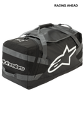 Alpinestars Goanna Bag, borsone da motocross, nero e grigio antracite con loghi bianchi, grande logo a stella laterale e scritta, base in telone resistente, cinghie di trasporto rinforzate, ampio spazio per l'attrezzatura da gara fuoristrada
