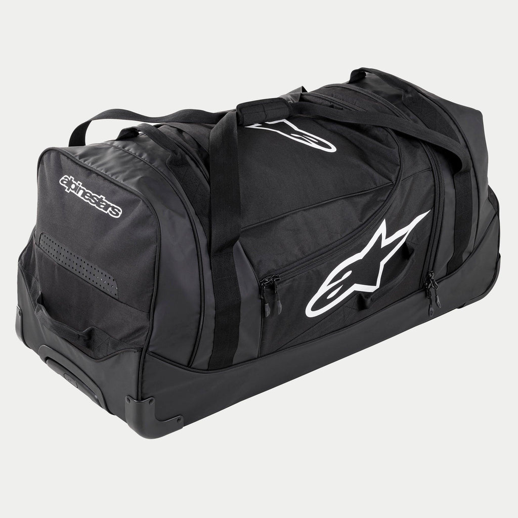 Alpinestars Komodo Travel Bag, grande borsa per attrezzatura da motocross in nero e antracite con loghi bianchi, dotata di ruote e maniglia telescopica, costruzione resistente per il trasporto di equipaggiamento da gara
