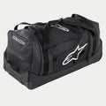 Alpinestars Komodo Travel Bag, grande borsa per attrezzatura da motocross in nero e antracite con loghi bianchi, dotata di ruote e maniglia telescopica, costruzione resistente per il trasporto di equipaggiamento da gara