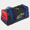 Alpinestars Komodo Travel Bag, borsa porta attrezzatura con ruote, nero blu rosso e giallo fluo, con maniglie blu, pannello laterale rosso e loghi giallo fluo, struttura resistente con ruote per il trasporto di attrezzatura da motocross e racing