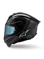 Casco Alpinestars Supertech R10 Solid, casco integrale racing da moto, carbonio nero opaco e lucido, trama in fibra di carbonio a vista, logo Alpinestars bianco sul lato, design aerodinamico con spoiler posteriore integrato e prese d'aria, vista laterale di profilo